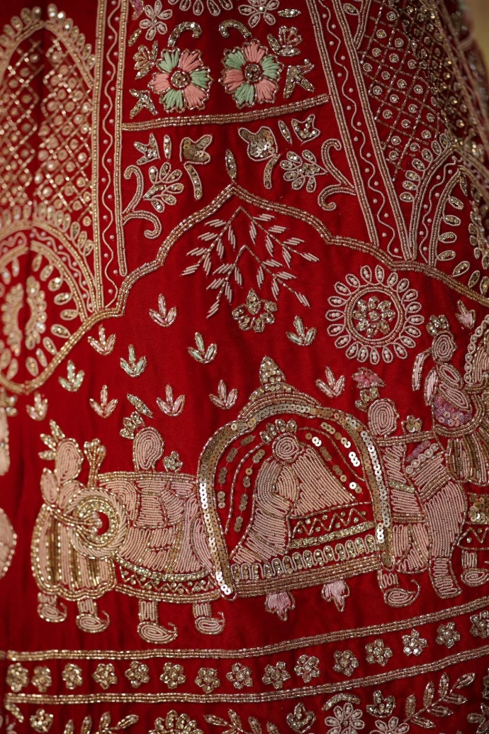 A close up of a red and gold dress